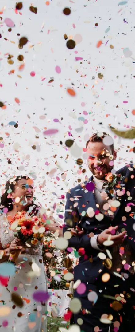 Novios saliendo de su matrimonio entre confeti
